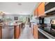 Open concept kitchen with stainless steel appliances and granite island at 11537 Southern Creek Dr, Gibsonton, FL 33534