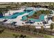 Resort-style pool area with a lazy river, lounge chairs, and umbrellas at 5700 Spivey Ct, Wesley Chapel, FL 33545
