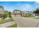 Two-story house with three-car garage and manicured lawn at 20123 Oakflower Ave, Tampa, FL 33647