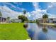 Tranquil canal-side view with lush greenery and clear blue sky at 4976 Britni Way, Zephyrhills, FL 33541