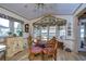 Bright sunroom with water views, table for four, and built-in shelving at 4976 Britni Way, Zephyrhills, FL 33541