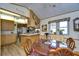 Cozy dining area with a round table and views to the kitchen at 4976 Britni Way, Zephyrhills, FL 33541