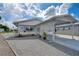 Single-story home with carport and landscaped yard at 4976 Britni Way, Zephyrhills, FL 33541