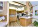 Open kitchen with island and colorful backsplash at 4976 Britni Way, Zephyrhills, FL 33541