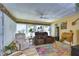 Bright sunroom featuring leather recliners and a colorful rug at 4976 Britni Way, Zephyrhills, FL 33541