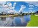 Beautiful canal-front property with RVs and lush green grass at 4976 Britni Way, Zephyrhills, FL 33541