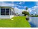 Picturesque waterfront view of canal, lush landscaping, and homes at 4976 Britni Way, Zephyrhills, FL 33541