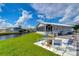 Inviting patio with table and chairs, overlooking a peaceful canal at 4976 Britni Way, Zephyrhills, FL 33541