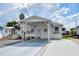 Single-story home with carport and landscaped yard at 4976 Britni Way, Zephyrhills, FL 33541