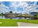 Serene waterfront view with canal, lush landscaping and homes at 4976 Britni Way, Zephyrhills, FL 33541