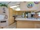 Kitchen with wood cabinets and decorative wall art at 4976 Britni Way, Zephyrhills, FL 33541
