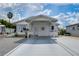 Single-story home with carport and landscaped yard at 4976 Britni Way, Zephyrhills, FL 33541