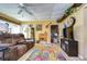 Living room with brown leather seating and a fireplace at 4976 Britni Way, Zephyrhills, FL 33541