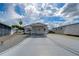 Single-story home with carport and landscaped yard at 4976 Britni Way, Zephyrhills, FL 33541