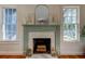 Elegant fireplace with a green mantel and marble surround at 921 Newberger Rd, Lutz, FL 33549