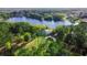 Aerial view of house on a lake with circular driveway at 921 Newberger Rd, Lutz, FL 33549