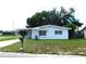 White single story home with carport and lawn at 5904 Elm St, New Port Richey, FL 34652