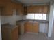 Bright kitchen featuring wood cabinets and a double sink at 2424 W Tampa Bay Blvd # 108, Tampa, FL 33607