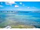 Aerial view of coastline with clear water and distant buildings at 220 Belleview Blvd # 802, Belleair, FL 33756