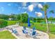 Community patio with seating area overlooking a tranquil pond at 220 Belleview Blvd # 802, Belleair, FL 33756