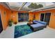 Covered patio with comfortable seating and vibrant decor at 7906 Willow Brook Ct, Hudson, FL 34667