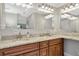 Double vanity bathroom with granite countertop and modern lighting at 1111 67Th Nw St, Bradenton, FL 34209