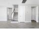 Hallway and staircase with neutral color palette and wood-look tile flooring at 1946 Longliner Loop, Wesley Chapel, FL 33543