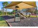 Community playground with slides, swings, and a shaded play area for enjoyment and recreation at 2944 Prairie Iris Dr, Land O Lakes, FL 34638