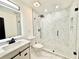 Bathroom features vanity and frameless glass shower with marble style tile at 6710 Myrna Dr, Tampa, FL 33619