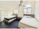 Airy bedroom showcases two beds, side tables and bright window light at 6710 Myrna Dr, Tampa, FL 33619
