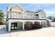 Home featuring a large balcony, black framed windows and accents, and gray exterior at 6710 Myrna Dr, Tampa, FL 33619
