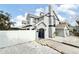 The house features a stylish exterior, complemented by a white fence and white rock landscaping at 6710 Myrna Dr, Tampa, FL 33619