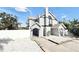 The property features a stylish exterior, complemented by a white fence and white rock landscaping at 6710 Myrna Dr, Tampa, FL 33619