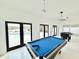 Game room features a pool table, foosball table and access to outdoor pool area at 6710 Myrna Dr, Tampa, FL 33619