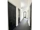 Hallway features black interior doors and dark hardwood floors at 6710 Myrna Dr, Tampa, FL 33619