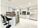 Spacious kitchen featuring a large island with seating, stainless steel appliances, and wine fridge at 6710 Myrna Dr, Tampa, FL 33619