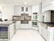 Well-equipped kitchen featuring modern appliances, a stainless steel sink, and updated countertops at 6710 Myrna Dr, Tampa, FL 33619