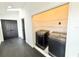 Laundry area with washer and dryer hookups, black flooring, and white walls at 6710 Myrna Dr, Tampa, FL 33619