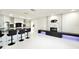 Open concept space with a modern fireplace, kitchen bar seating, and sleek, clean lines at 6710 Myrna Dr, Tampa, FL 33619