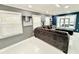 Open living room with large sectional sofa, recessed lighting, and picture windows at 6710 Myrna Dr, Tampa, FL 33619