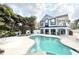 Enjoy the waterfront view with this tranquil pool and surrounding tropical landscape at 6710 Myrna Dr, Tampa, FL 33619
