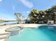 Enjoy the waterfront view with this tranquil pool and surrounding tropical landscape at 6710 Myrna Dr, Tampa, FL 33619