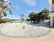 Backyard pool and spa with stone landscaping, palm trees, and waterfront view at 6710 Myrna Dr, Tampa, FL 33619