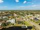 Aerial view showcasing a neighborhood with houses, canals, and mature trees at 5823 Dory Way, Tampa, FL 33615