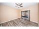 Bedroom with wood-look flooring and sliding glass doors to a patio at 3508 Magnolia Ridge Cir # 301, Palm Harbor, FL 34684