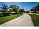 Walking path in the community with greenery and a bike at 3508 Magnolia Ridge Cir # 301, Palm Harbor, FL 34684