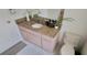 Bathroom vanity featuring a granite countertop, single sink, and pink cabinetry at 4467 Worthington Ct, Palm Harbor, FL 34685