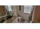 Bathroom featuring a granite countertop, a shower with curtain, and pink tile at 4467 Worthington Ct, Palm Harbor, FL 34685