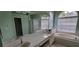 Bright primary bathroom with double sinks, a large mirror, and a separate soaking tub at 4467 Worthington Ct, Palm Harbor, FL 34685