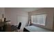 Bedroom featuring neutral walls, a double closet, and a bright window with blinds at 4467 Worthington Ct, Palm Harbor, FL 34685